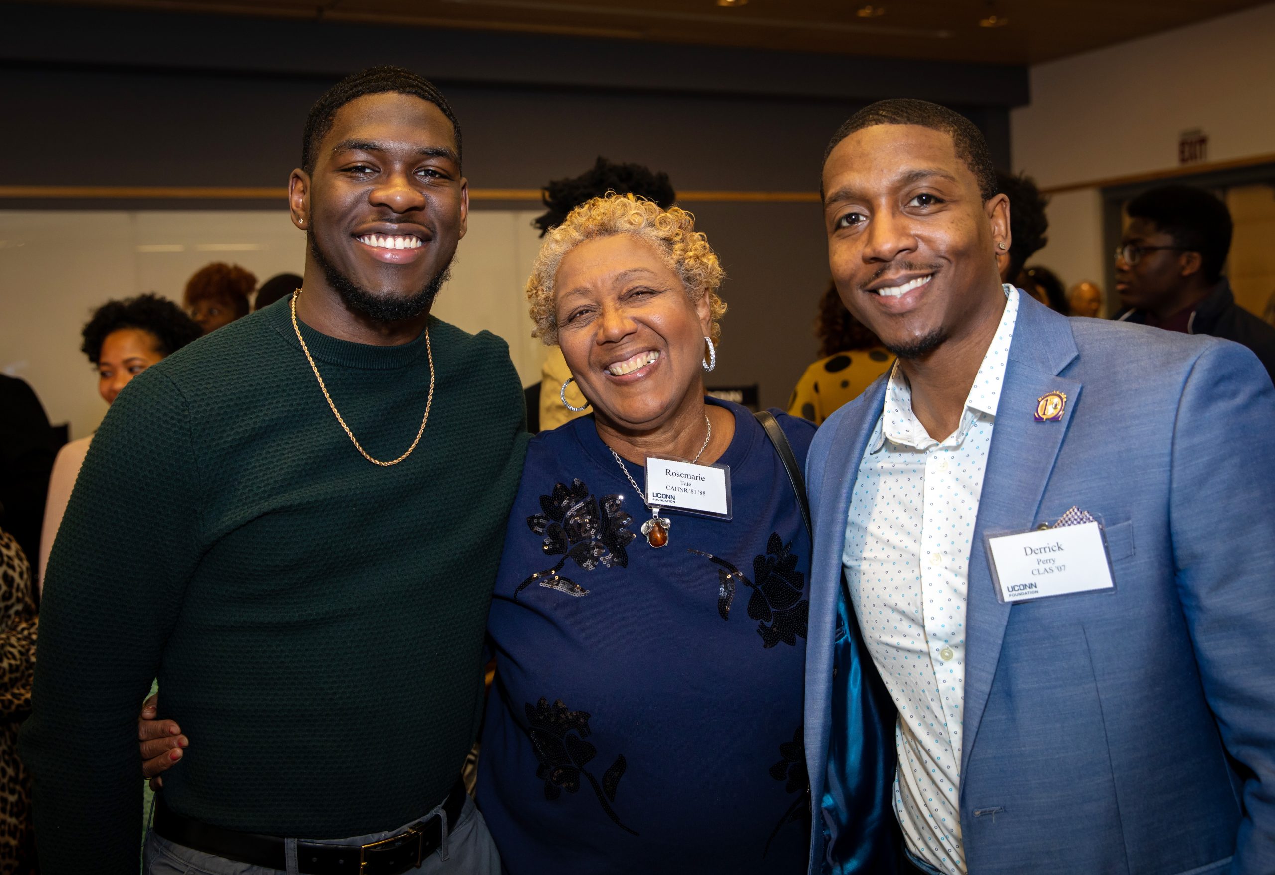 Three members of the African American Alumni Council smiling at an alumni event