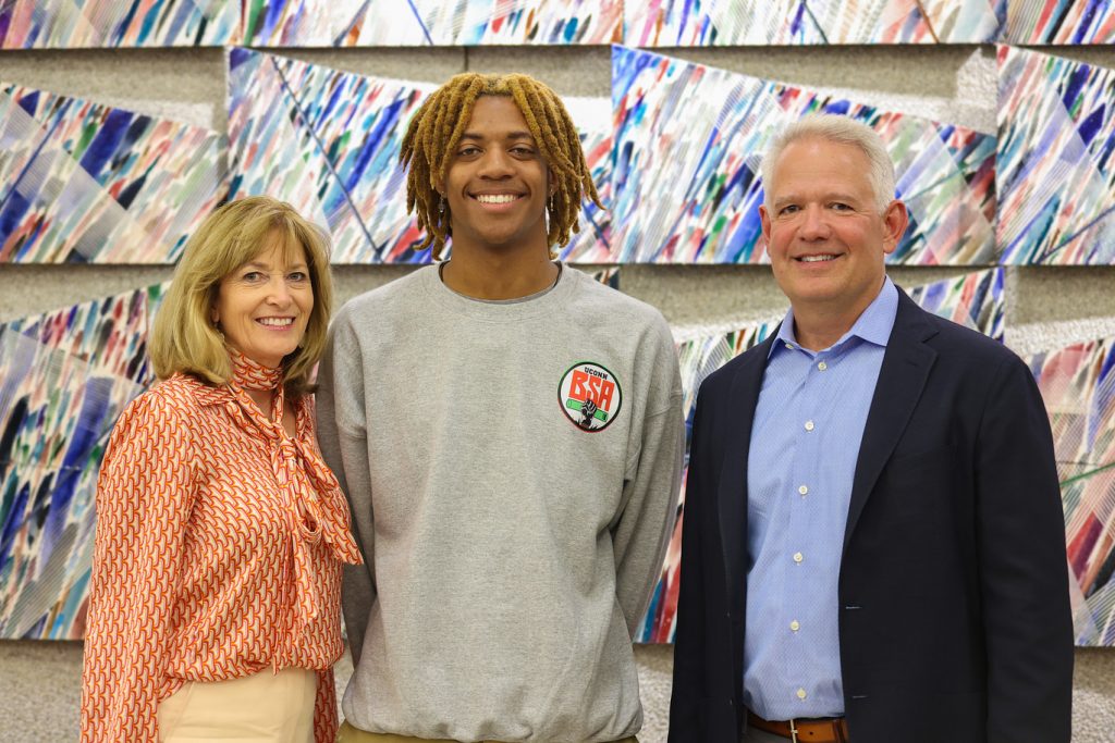 Kathleen LaBrosse, Kamari Cross, and Joe LaBrosse standing from left to right smiling