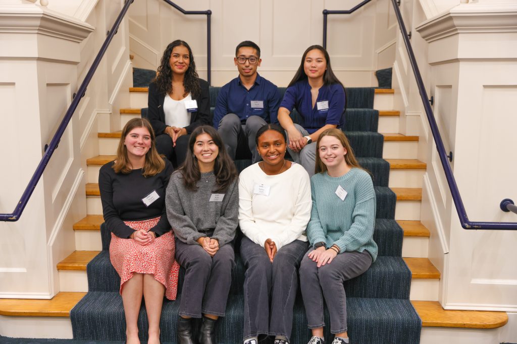 A group photo taken on the stairs of the Great Hall during First Gen Networking Night at the UConn Alumni Center