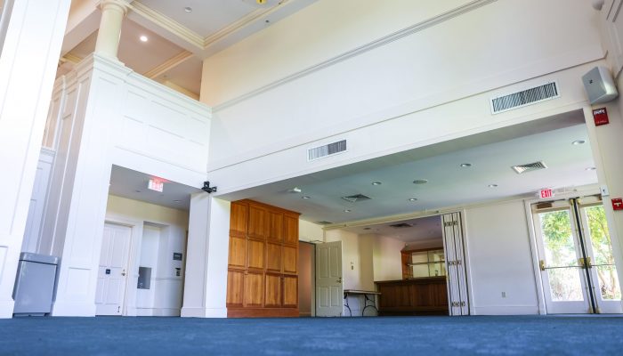 One side of the Great Hall, featuring a wooden bar, large closet, and an exit door