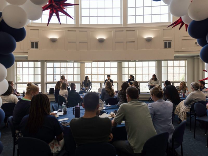 Students seated in the Great Hall facing Foundation employees, as they speak about the students first pillar of the Because of UConn campaign.