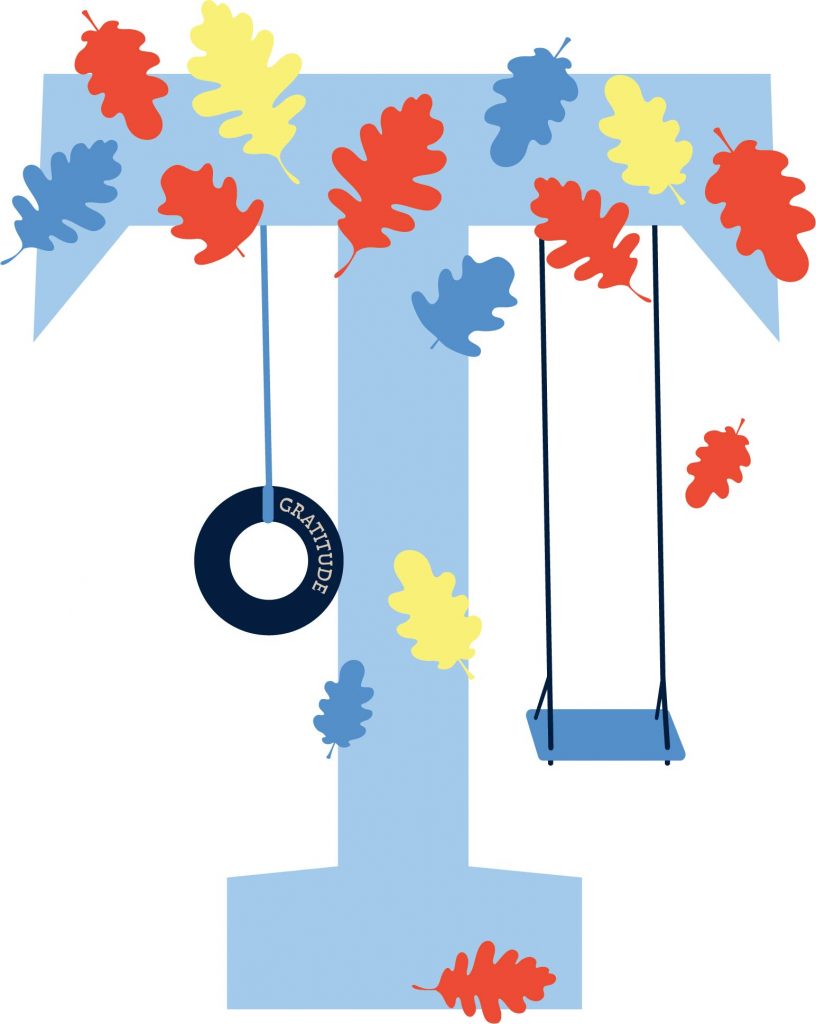 Light blue letter "T" decorated with colorful red, blue, and yellow leaves, a tire swing labeled "Gratitude," and a blue playground swing.