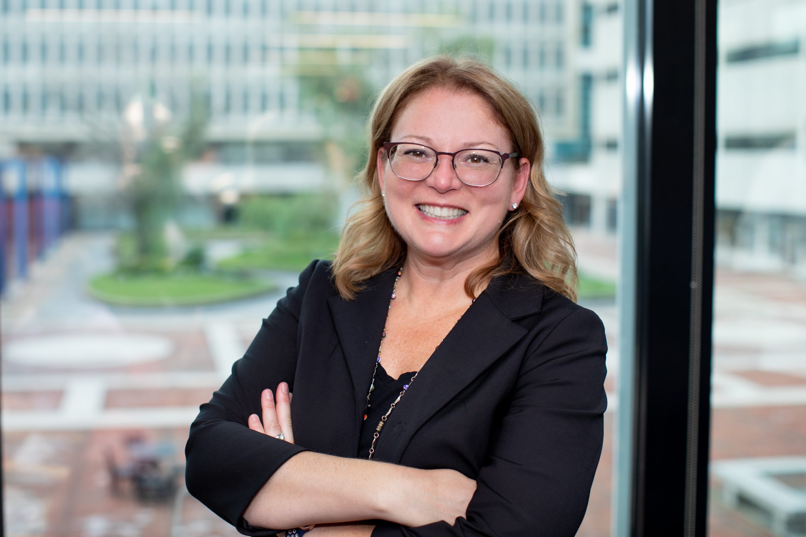 Sandra Chafouleas in business attire smiling with arms crossed