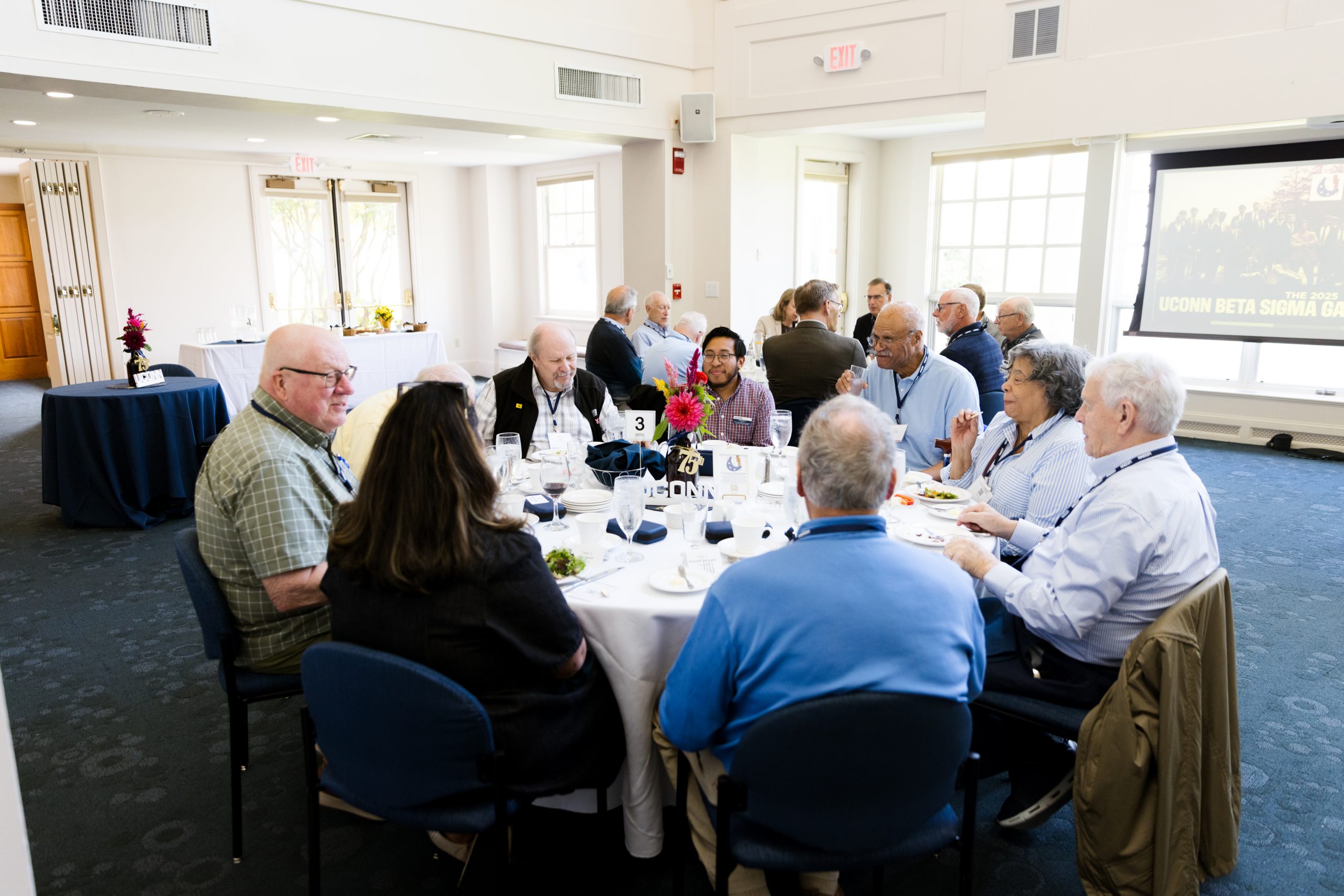 People gathered at a table in the Alumni Center Great Hall
