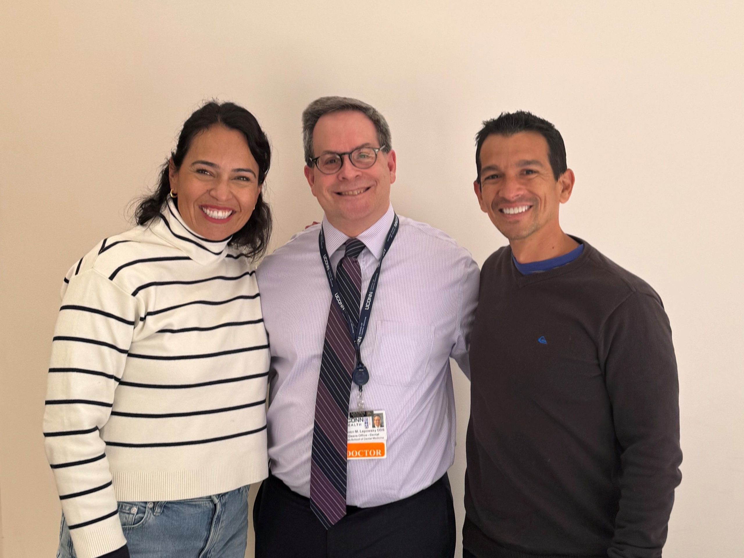 Dr. Cynthia Alegre, Dr. Steven Leposky, and a second man smiling and posing for a picture.