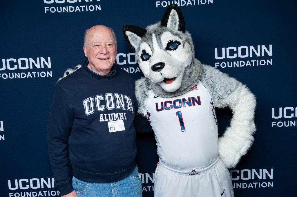 Larry Handler - UConn's most loyal donor - posing with the Jonathan the Husky mascot