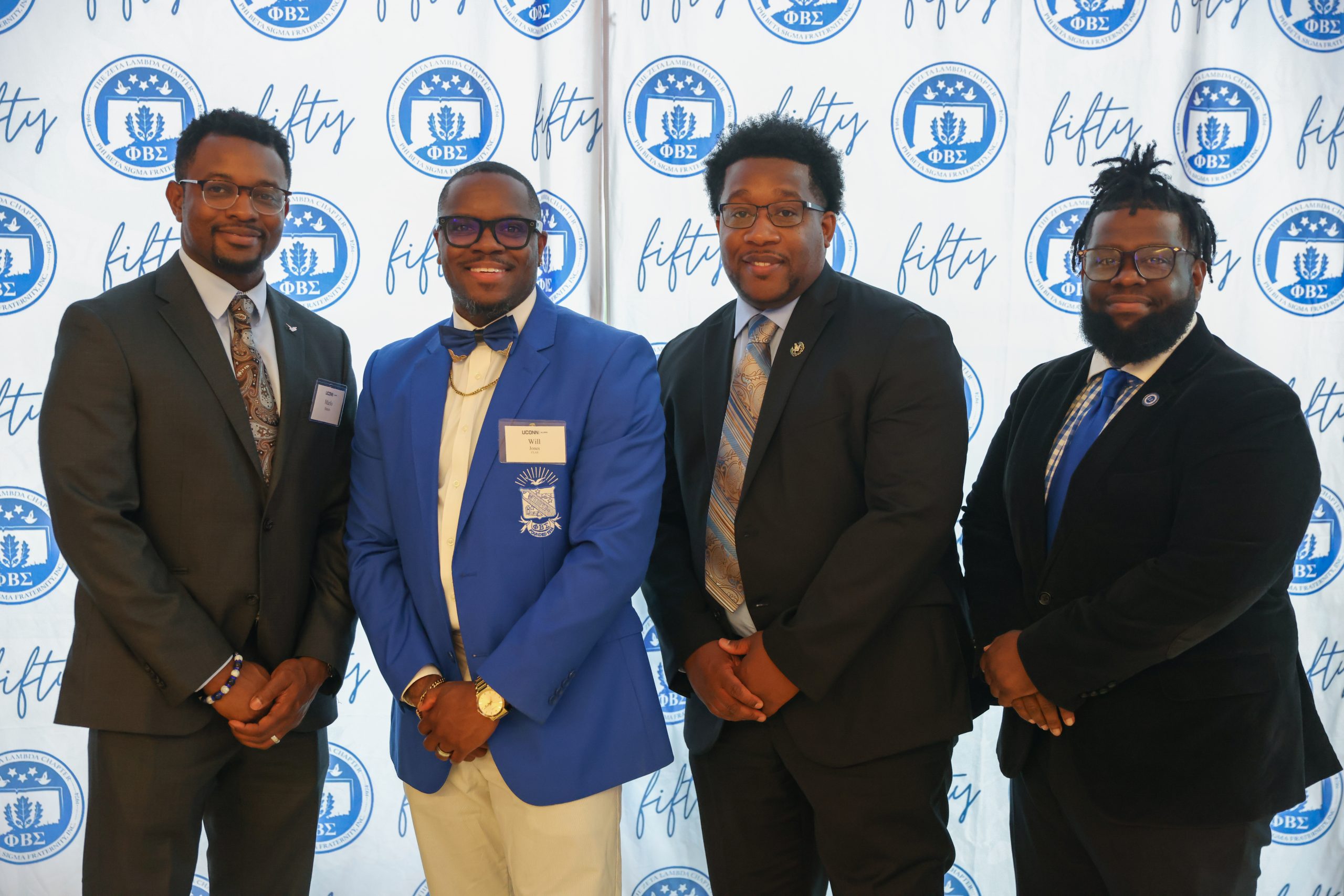 Men lined up for a photo at the Phi Beta Sigma 50th Reunion in the UConn Student Union