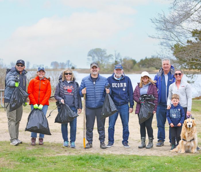 UConn Cares 2024 Beach Clean Up The UConn Cares beach clean up crew posing for a picture holding their trash cans