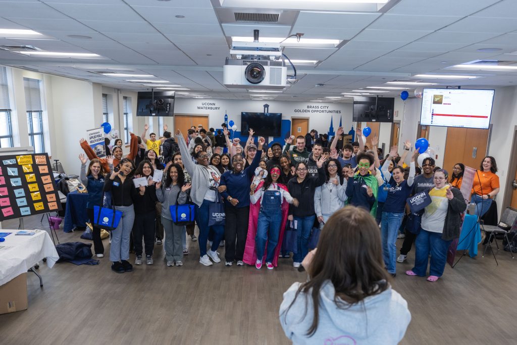 UConn Waterbury SHAW Fresh Check 2025 members standing in a group, putting their arms in the air, and smiling