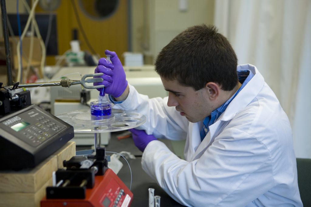 David Lindsay, a biomedical engineering student working in a chemistry lab.