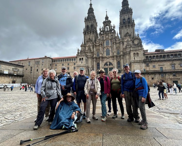 Camino A group of travelers during the "Camino de Santiago" travel trip posing behind a castle in a town square