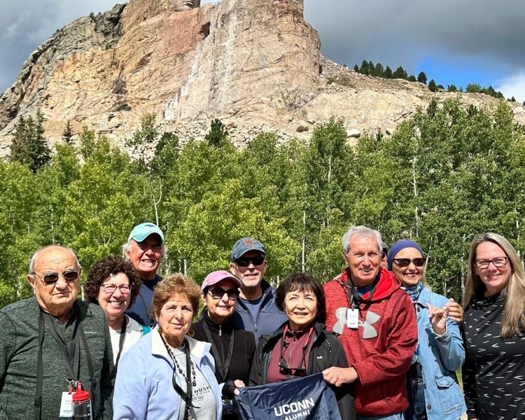 Dakota Travel A group of travelers posing behind Mount Rushmore in South Dakota