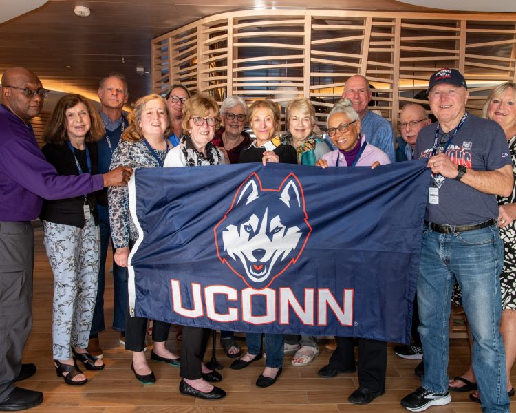 No-193 A group of people holding up a UConn flag