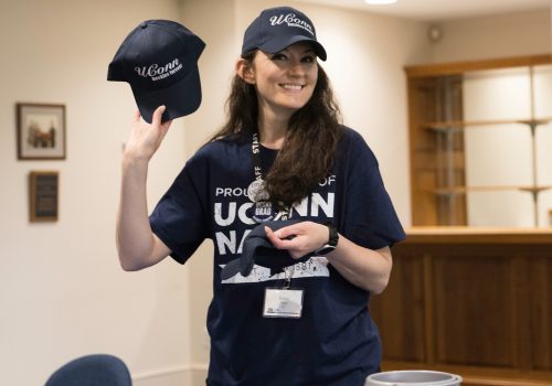 Senior Send-off A volunteer holding up a hat during senior send-off