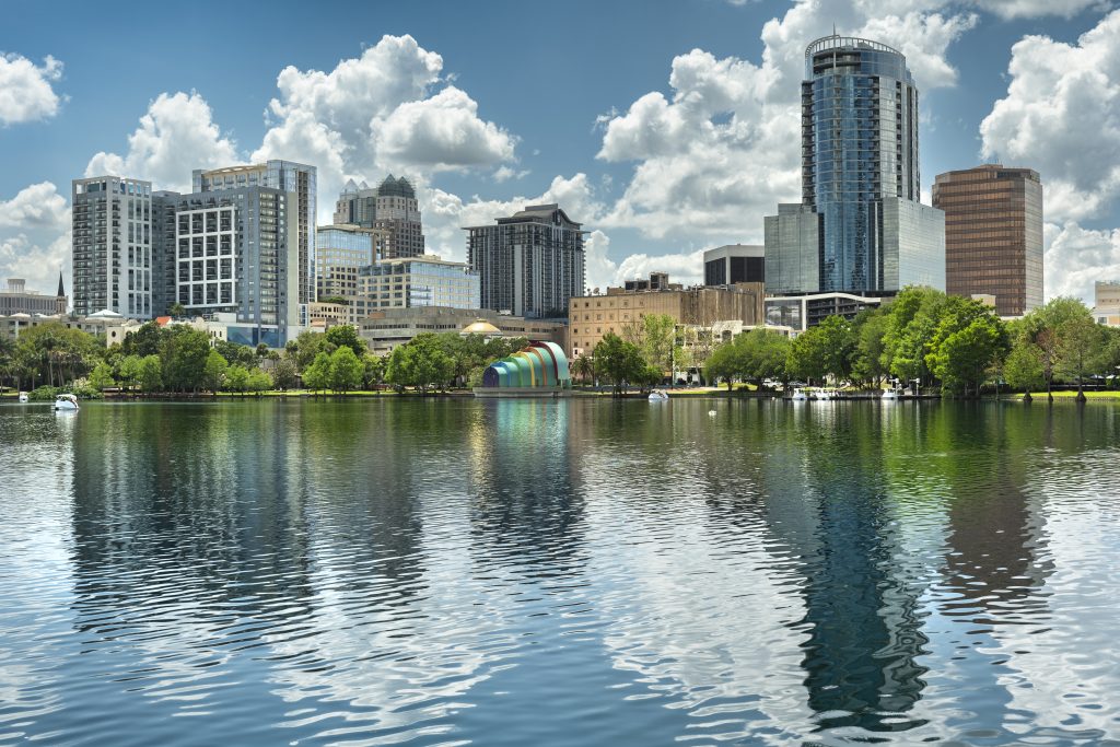 Orlando, Florida city skyline over the waters of Lake Eola park in downtown