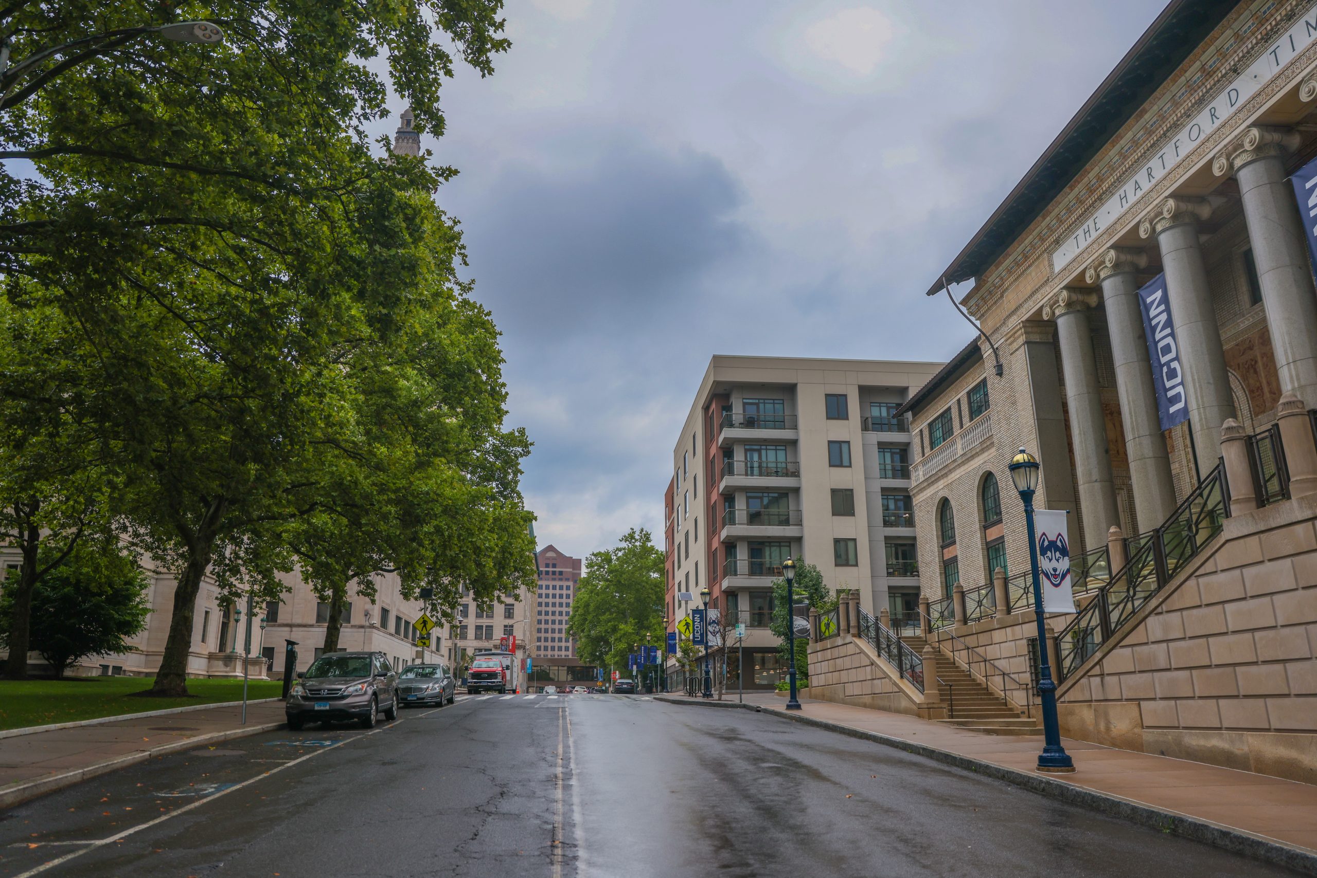 A UConn Hartford campus building with columns and banners, on an overcast day