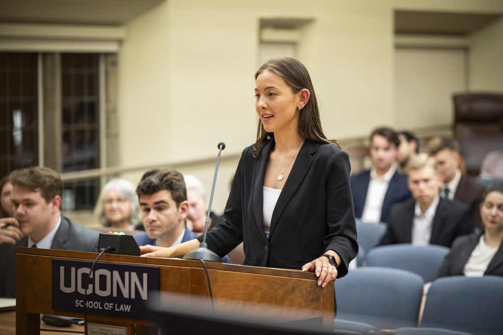 A law student speaking at a podium