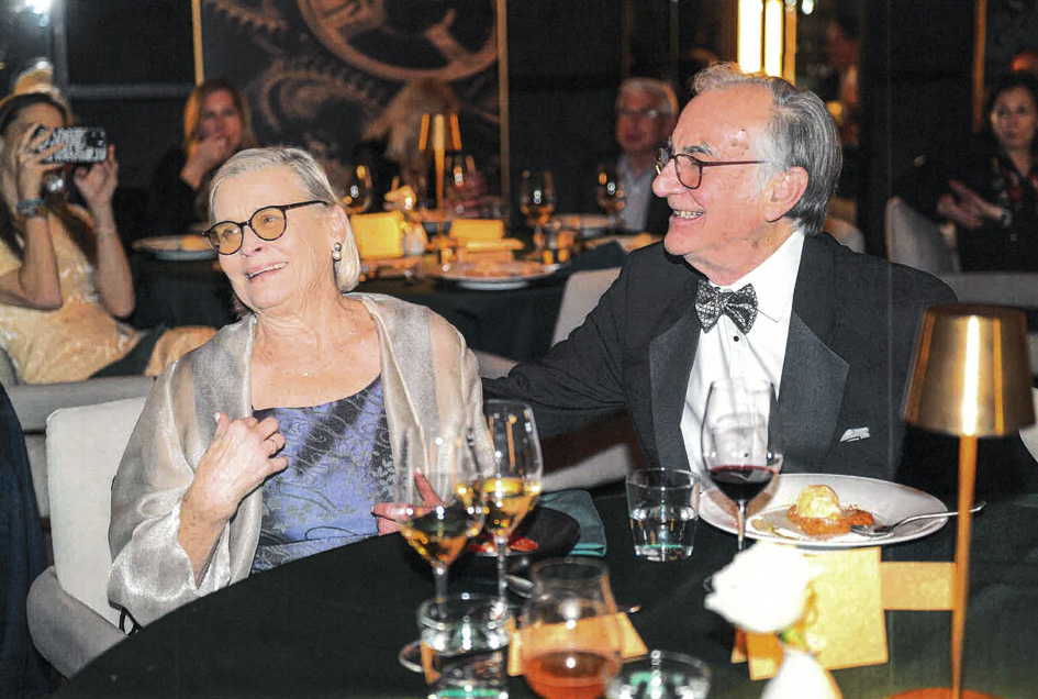Wes and Chloe Horton smiling at a dinner table