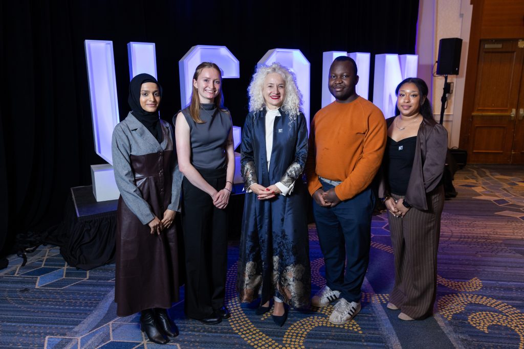 Sana Lulat, Sarah Trainor, Radenka Maric, Sam Rookwood, Emily Pascal at the Annual Scholarship Celebration, posing in front of a lit "UCONN" sign